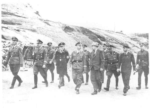 Reich Chief of the SS Heinrich Himmler (5th from left) during an inspection of the Kastenhof Quarry, accompanied by Ernst Kaltenbrunner (1st from left), at this time a Senior SS and Police Commander in Vienna; Karl Wolff (2nd from left), Head of the Personal Staff of the Reich Chief of the SS; August Eigruber (4th from left), Reich Governor of Oberdonau; Karl Mummenthey (6th from left), Head of Section W I (Stone and Earth) at the SS Economic and Administrative Office; Kurt Paul Wolfram (6th from left), Operations Manager of the DESt in Gusen, 1941 (photo credits: KZ-Gedenkstätte Mauthausen / Collections)
