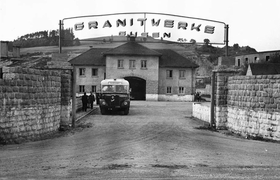Entry gate and former "Jourhaus" with the sign "Granitwerke Gusen"; this was the name of the company which was responsible for the further exploitation of the quarries by the Soviets; date unknown. (photo credits: Ministère de la Défense - Direction pour la Mémoire, le Patrimoine et les Archives)